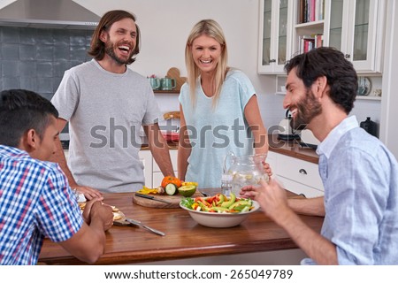 friends gathering party with salad and diversity in the kitchen