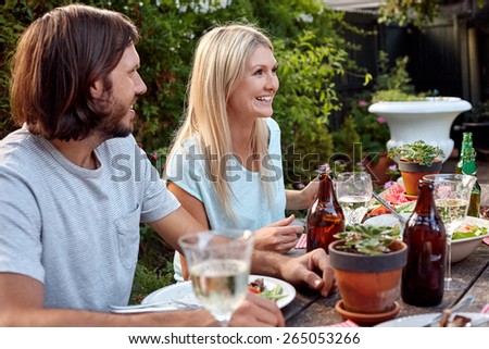 group of friends enjoying their outdoor dinner party