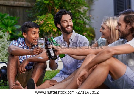 diverse group of friends having outdoor garden party with beer and wine drinks
