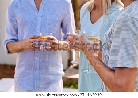 friends outdoors at garden party gathering with cocktail wine drinks