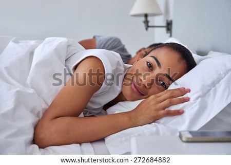 portrait of young women waking up early morning in bed