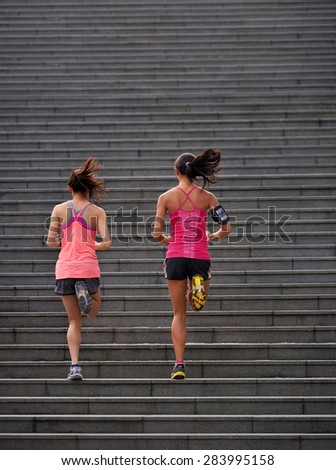 active sporty women working out running up stairs outdoors for morning workout