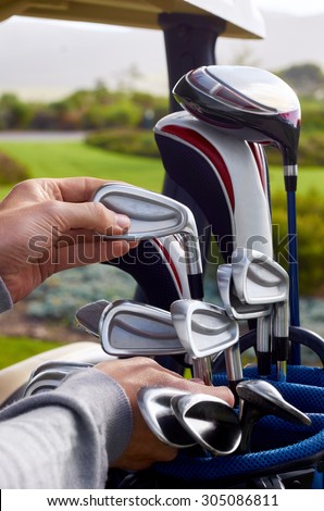 golfer choosing best club in bag