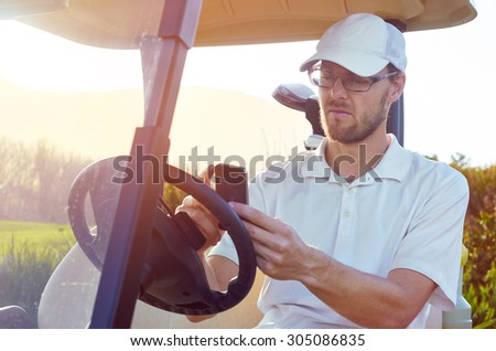 golf man relaxing on buggy cart with mobile cellphone summer vacation