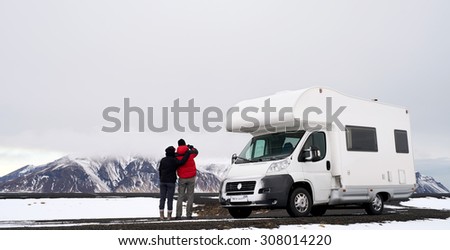 Travelling couple with Mobile motor home RV campervan driving through Iceland in recreational vehicle, freedom vacation motorhome lifestyle