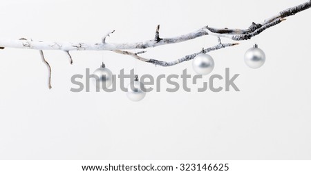 Silver christmas baubles on branch, simple minimalist elegant design