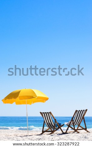 Two sun loungers and an umbrella on a perfect sunny day