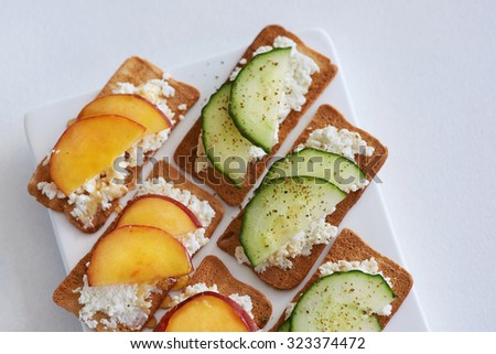 Fresh ricotta cottage cheese snack starter platter appetiser with sliced peach nectarine and cucumber, perfect party canapes
