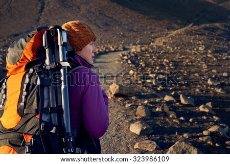 Young asian woman hiking in Iceland with backpack and outdoor gear on vacation holiday travel adventure