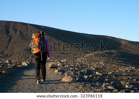 Young asian woman hiking in Iceland with backpack and outdoor gear on vacation holiday travel adventure