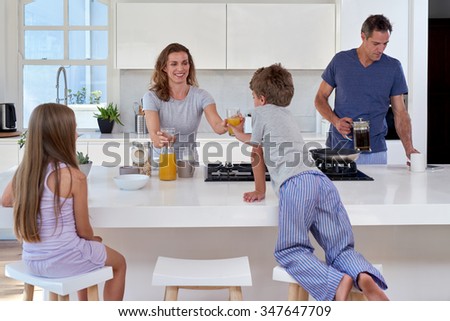 happy smiling caucasian family in the kitchen having breakfast