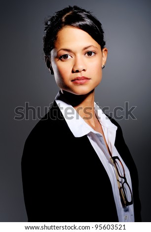 Professional in suit poses for a portrait, with dramatic lighting
