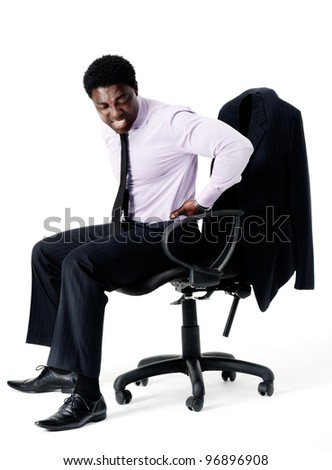 Black businessman in pain from sitting on his office chair with bad posture, long working hours concept. isolated on white