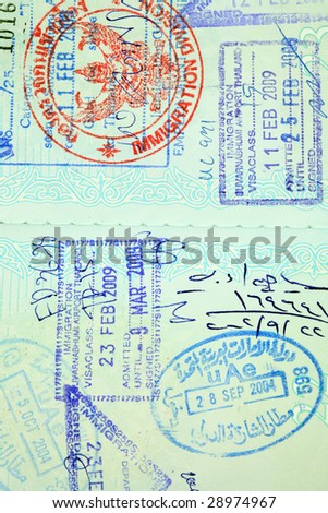 Visa entry and exit stamps in a passport.