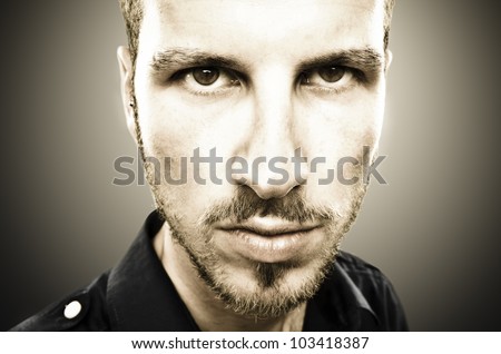 portrait of a young beautiful man, serious face expression