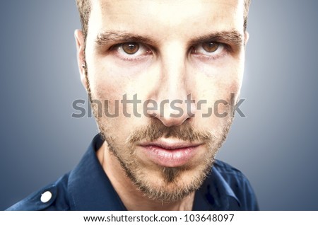 portrait of a young beautiful man, serious face expression