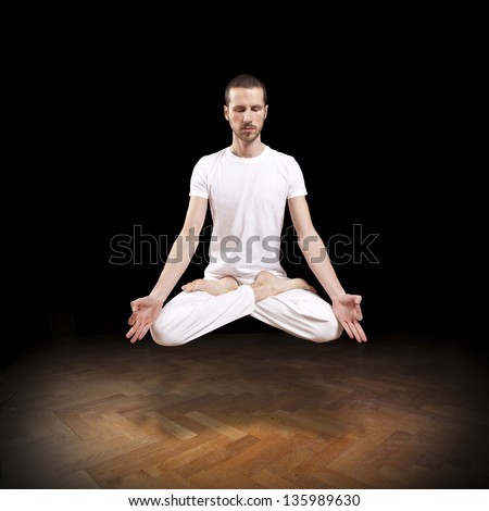 young man levitating in yoga position, meditation