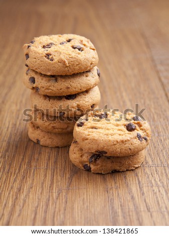 stack of chocolate biscuits with chocolate on wooden table