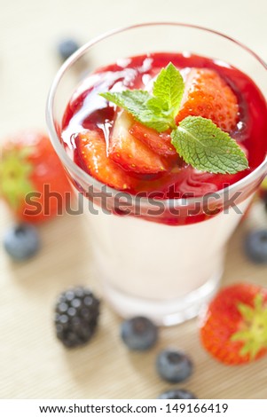 Pannacotta with wild berries and strawberry sauce, italian dessert
