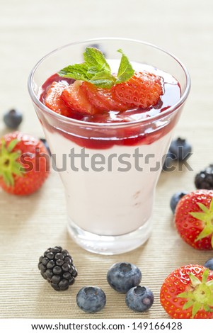 Pannacotta with wild berries and strawberry sauce, italian dessert
