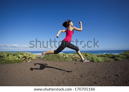 athlete woman running in nature. Healthy active lifestyle young woman exercising outdoors.