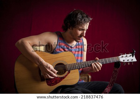 young cool guy playing acoustic guitar