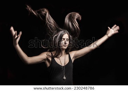 pretty brunette woman with long hair blowing up
