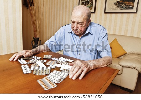 elder man with pills