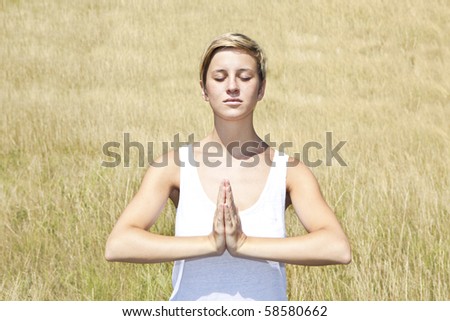 young woman practicing yoga outdoor
