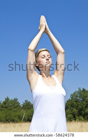 young woman practicing yoga outdoor