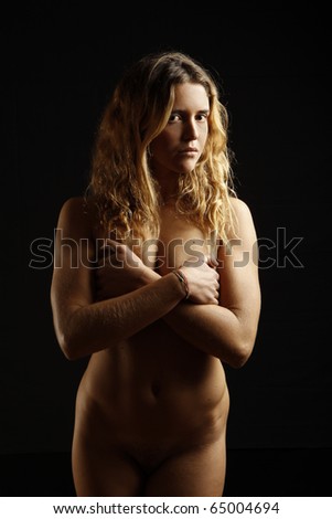 stock photo portrait of beautiful nude young girl on black background