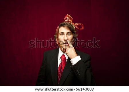 young funny guy with red ribbon on the head