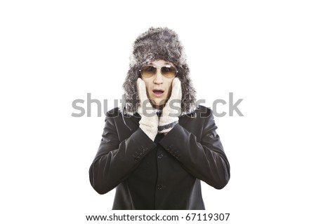 attractive young man wearing elegant black suit,sunglasses and russian hat