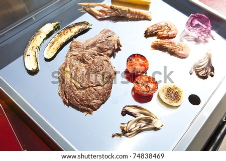 meat, vegetables and fish on the barbeque