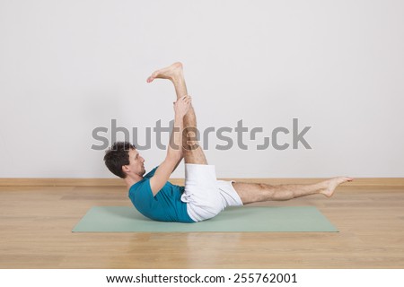 man practicing pilates indoor, return to life sequence, 34 exercise
