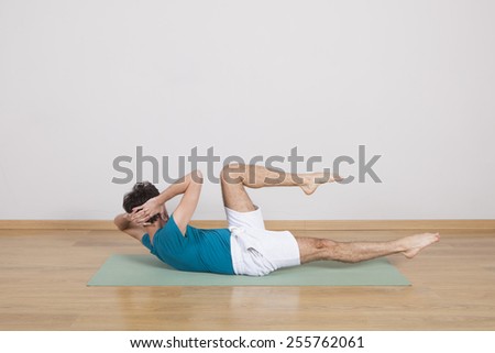 man practicing pilates indoor, return to life sequence, 34 exercise