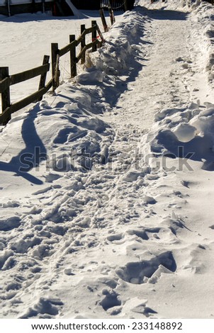 fence in deep snow, bright sun light
