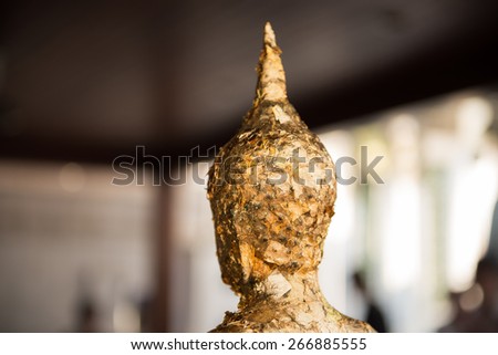 The gold leaf on the back of Buddha statue in temple of Thailand.