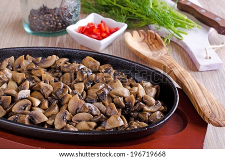 chopped and cooked mushrooms, lying in a frying pan