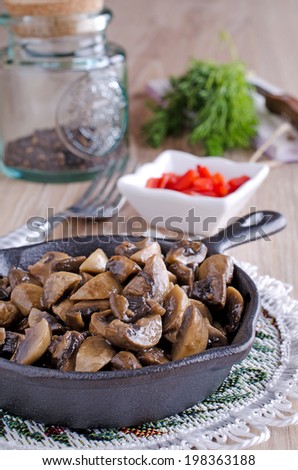 chopped and cooked mushrooms, lying in a frying pan