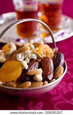almonds, dried apricots, cashews, dates, lying in a metal bowl