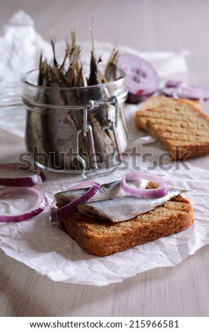 Sandwich with marinated anchovies and red onions