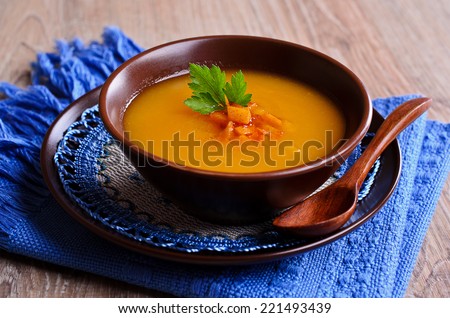 Soup orange color with chunks of roasted vegetables