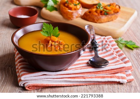 Soup orange color with chunks of roasted vegetables