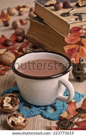 Drink light brown color in the circle on the background of fallen leaves and old books