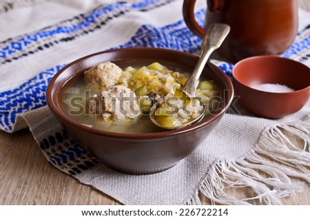 Thick soup with pearl barley, cucumbers and meatballs