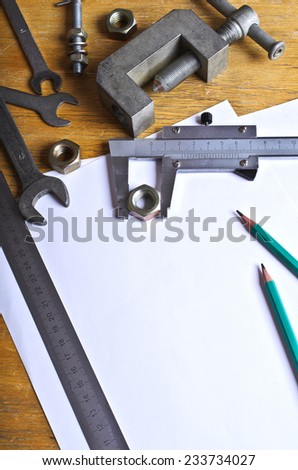 Various tools and mechanical devices on the white blank sheets for recording