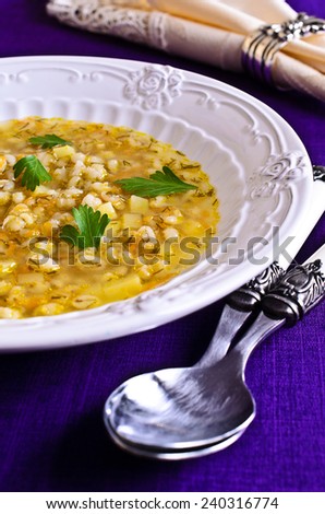 Soup with pearl barley and vegetables on the plate