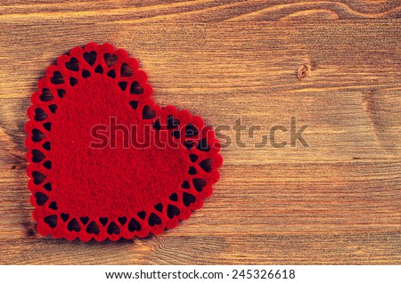 The texture of pure dark brown wood and red decorative heart
