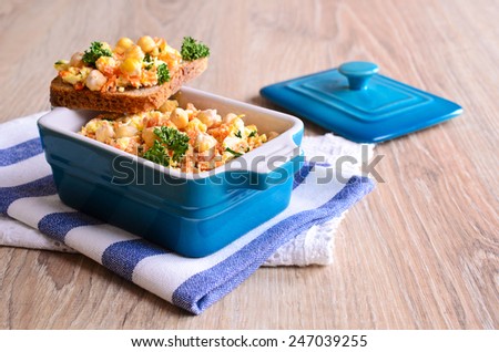 Carrot salad, cheese and chickpeas in a ceramic bowl